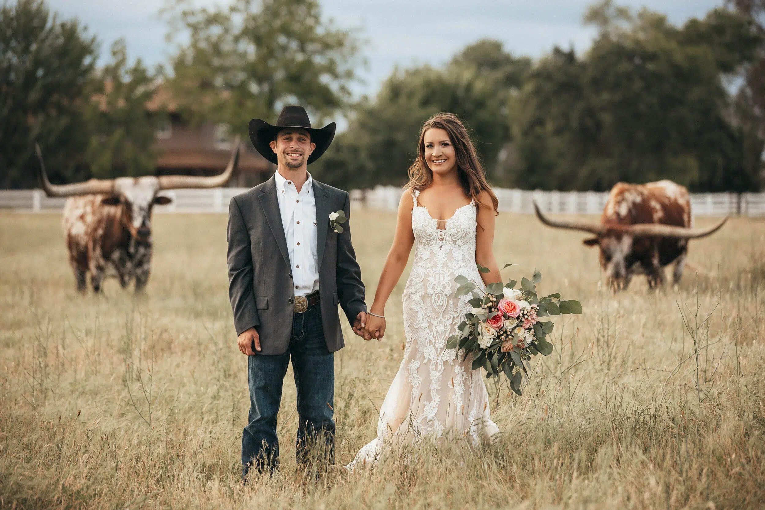 Outdoor ranch wedding ceremony in Southern California with rustic barn backdrop