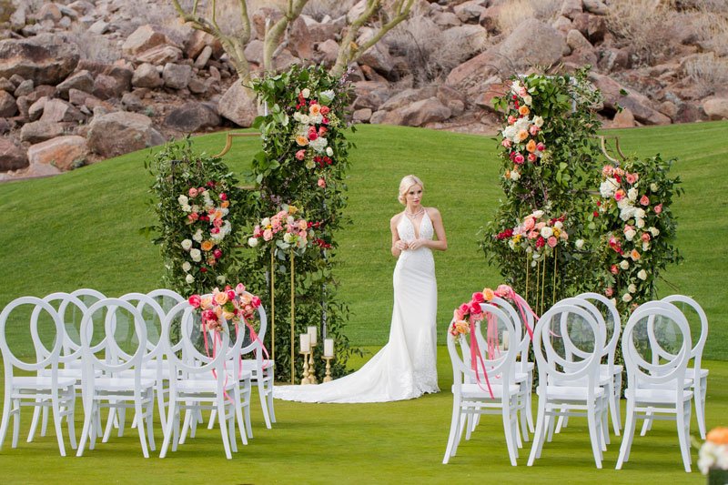 The Phoenician wedding ceremony lawn at sunset with mountain backdrop