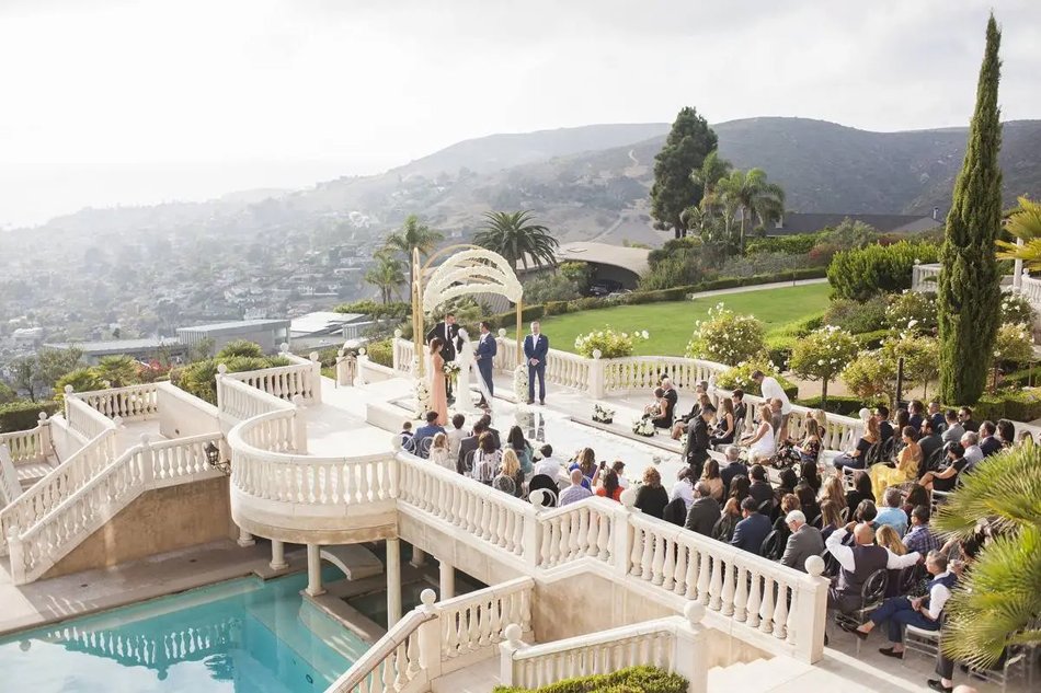 Luxury Laguna Beach Estate Wedding with Ocean View Terrace Laguna Beach private estate wedding ceremony on terraced balcony with ocean views and Mediterranean architecture in Orange County.
