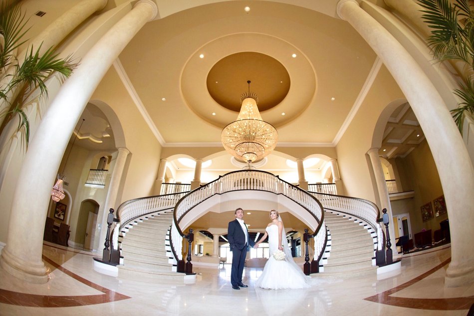 Grand Estate Wedding Entrance in Orange County Bride and groom in grand double-staircase foyer at a luxury Orange County estate wedding venue.