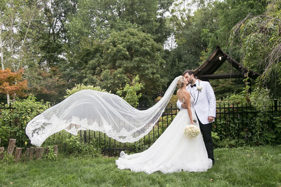 Bride and groom walking hand in hand down garden path at Los Angeles wedding