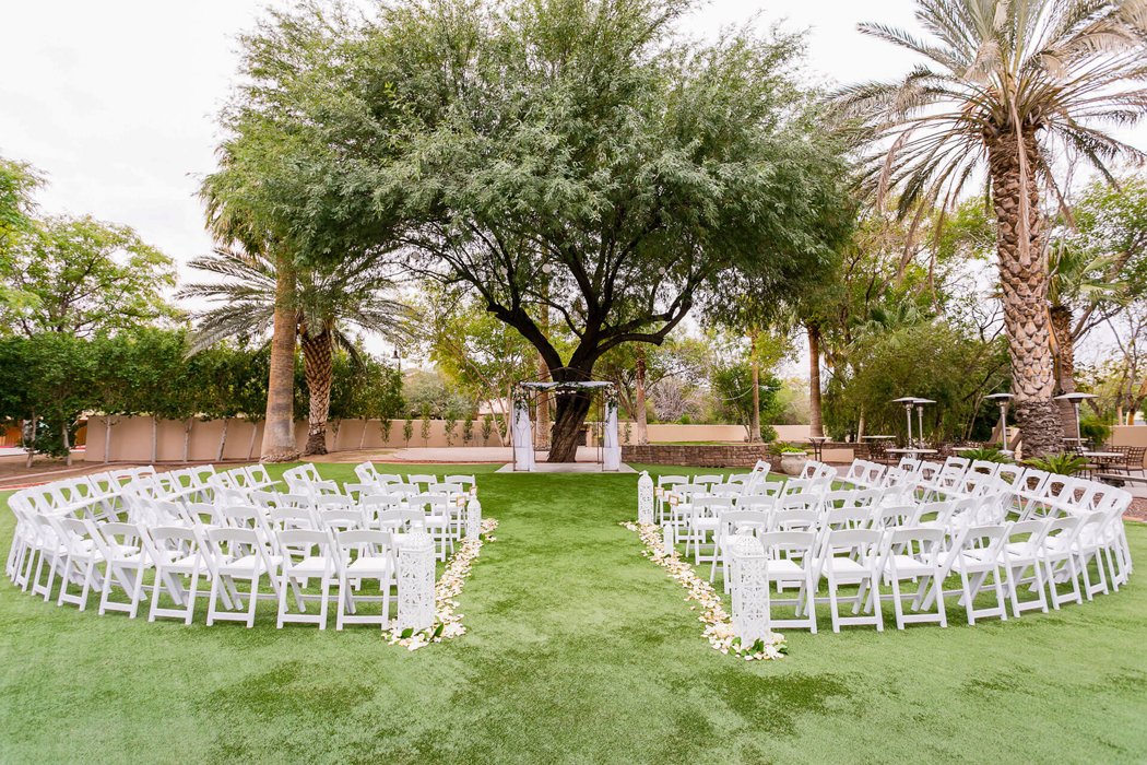 Outdoor wedding ceremony under trees at The Secret Garden Event Center in Phoenix