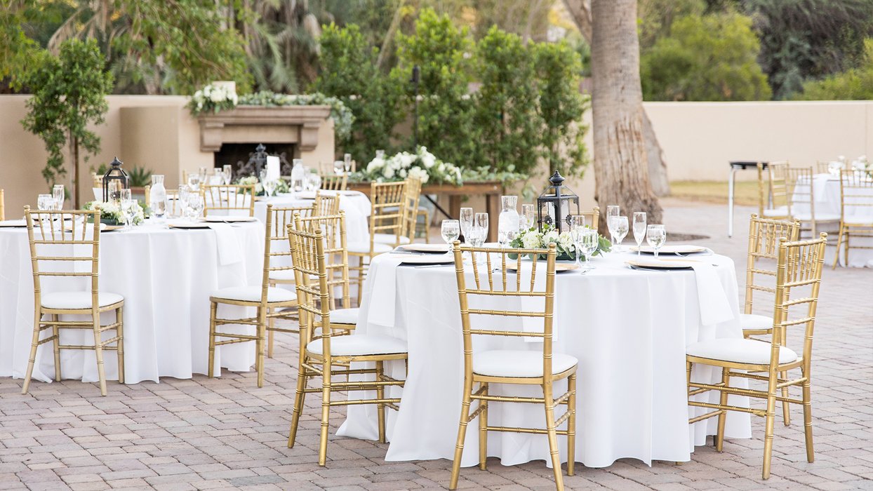 Bride and groom walking through greenery at The Secret Garden