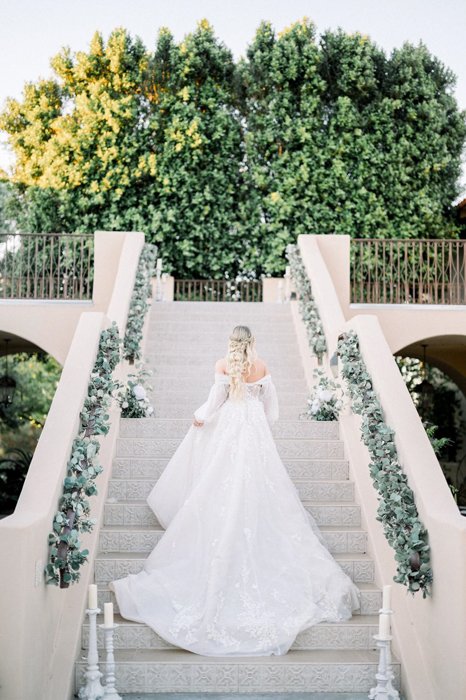 Detail shot of floral arrangements and candlelit tables at The Secret Garden Event Center