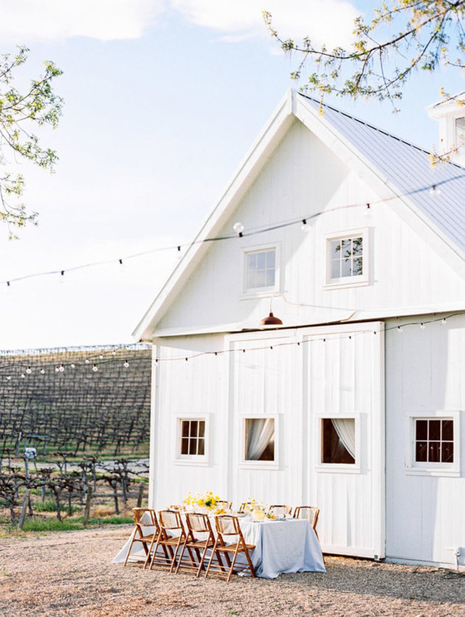 Minimal white-barn reception among vineyards—California wine country within driving distance of Phoenix.