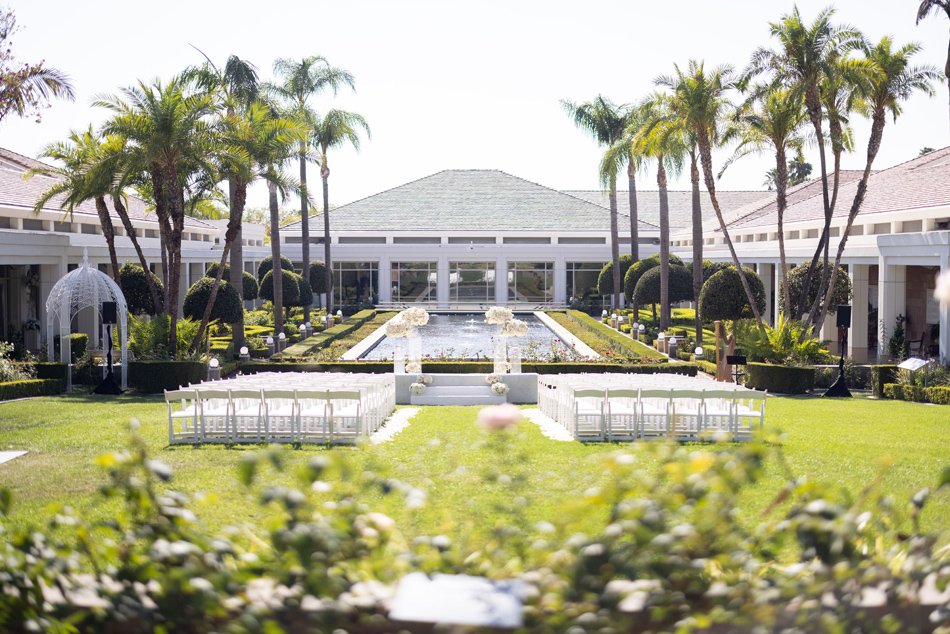 Monarch Beach Courtyard Ceremony, Dana Point Outdoor ceremony courtyard with reflecting pool and palm trees at a Dana Point luxury resort.