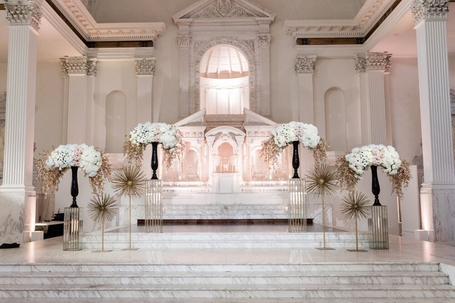 Cathedral-Style Wedding Ceremony in Downtown Los Angeles Grand ballroom setup with marble columns and floral arrangements at Taglyan Complex Los Angeles.