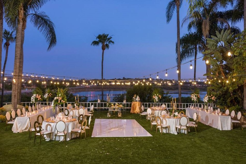 Newport Beach Marriott Bayview Wedding Reception String-lit outdoor wedding reception at Newport Beach Marriott Bayview overlooking water at dusk.