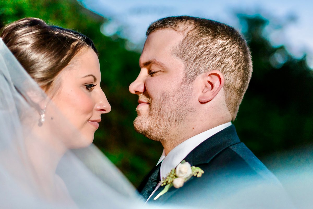 Close-up profile portrait of a bride and groom foreheads together at their Phoenix wedding