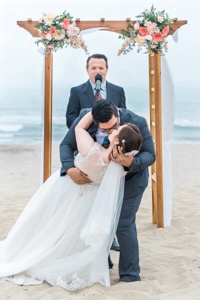 Bridal portrait with flowing veil against soft coastal fog