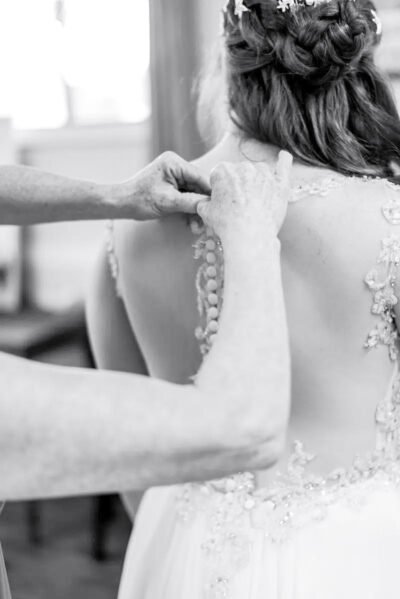 Bride and groom walking hand-in-hand along Ventura beach at sunset