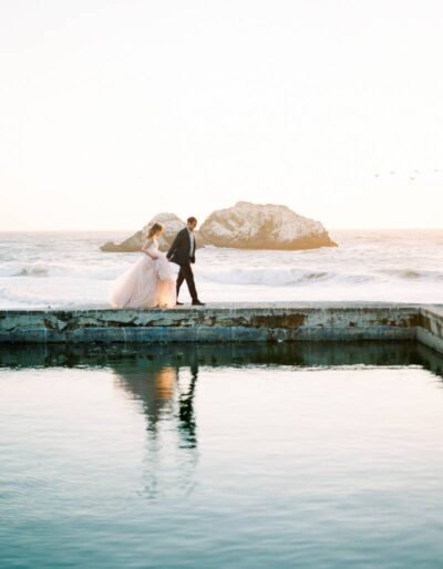 Couple on oceanfront walkway at sunset — California coast — Lovelee Photography