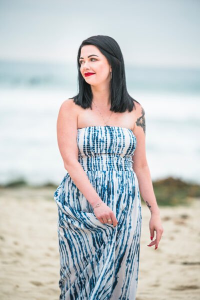 Wind-swept, elegant engagement photo with neutral-toned outfits san diego california engagement session